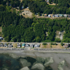 image of flooding river near homes and trees