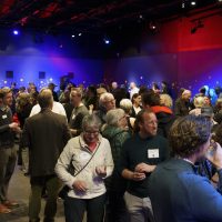 A group of people mingle at the pre-show reception
